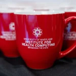 A photo of mugs with the IHC logo