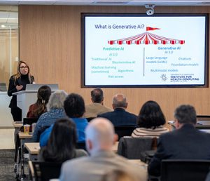 A photo of Dr. Goodman speaking at the UM-IHC